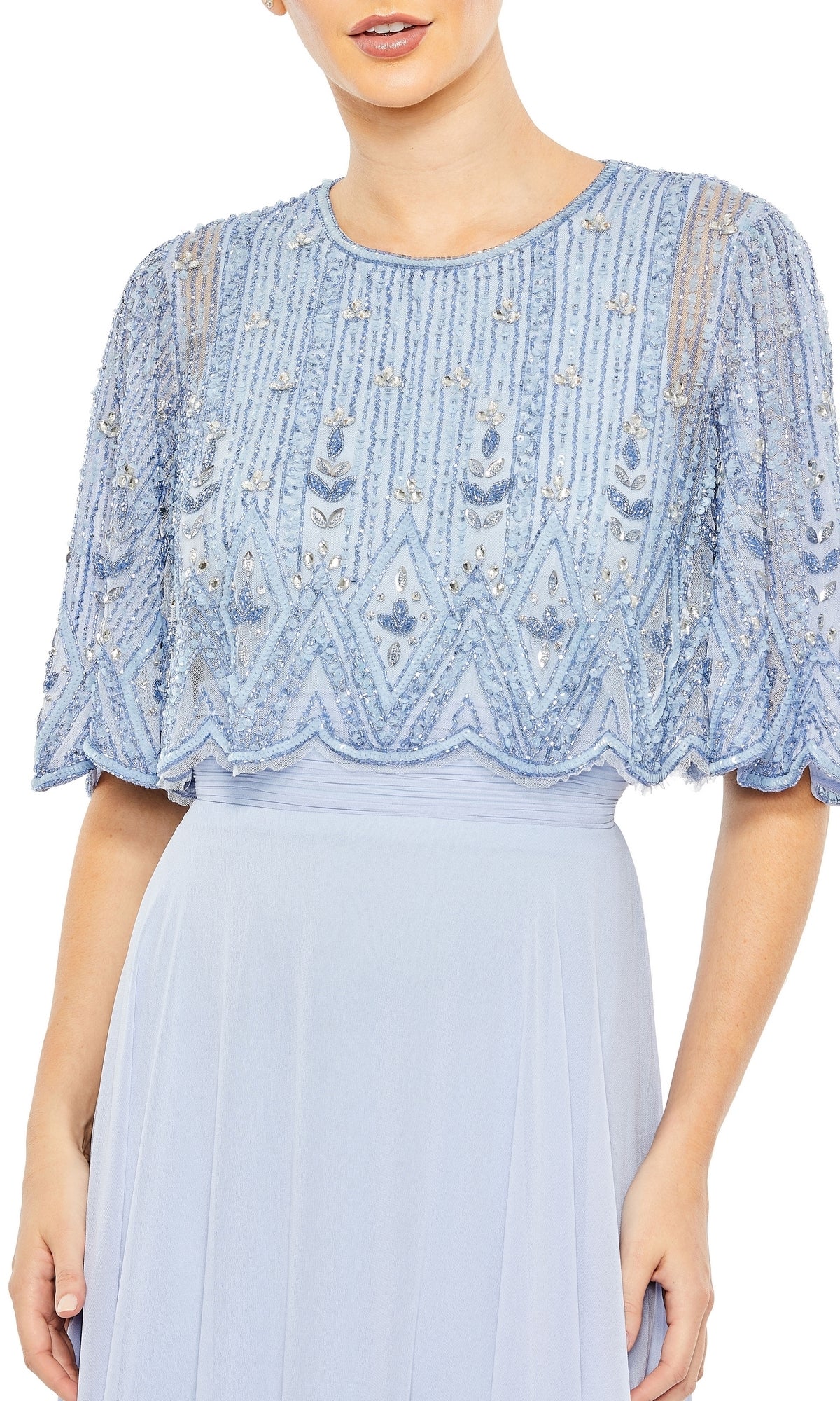 A woman wears the Mac Duggal 9181 Cape Sleeve Long Formal Dress in light blue, featuring short cape sleeves, a sheer overlay, and an intricately beaded and sequin-embellished bodice.
